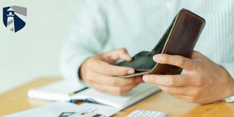 Man opening wallet that has no money inside